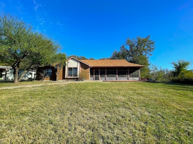 5001 Blue Bluff Rd, Austin, TX 78724 - view of front facade featuring a sunroom and a front lawn