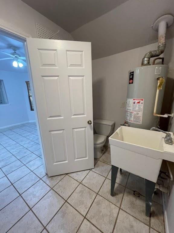5001 Blue Bluff Rd, Austin, TX 78724 - bathroom featuring gas water heater, tile patterned floors, a ceiling fan, and toilet