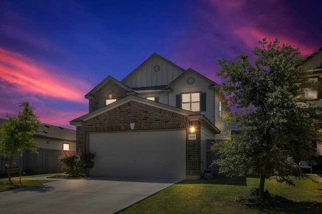 18909 James Carter Jr St, Manor, TX 78653 - view of front facade with board and batten siding, driveway, a garage, and brick siding