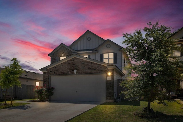 18909 James Carter Jr St, Manor, TX 78653 - view of front of property featuring board and batten siding, concrete driveway, a garage, and brick siding