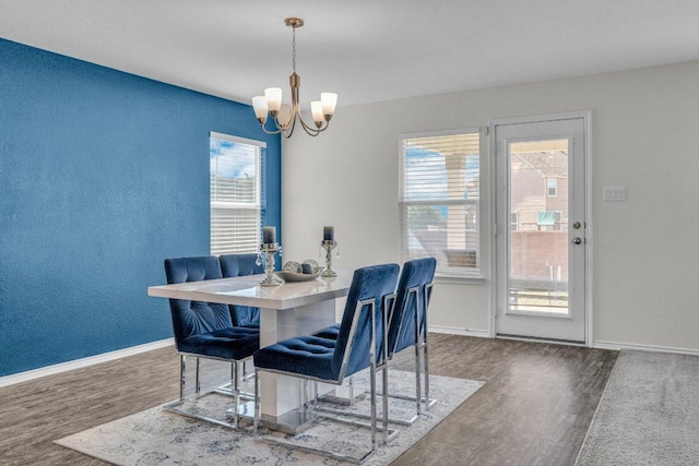 18909 James Carter Jr St, Manor, TX 78653 - dining space featuring wood finished floors, a chandelier, and plenty of natural light