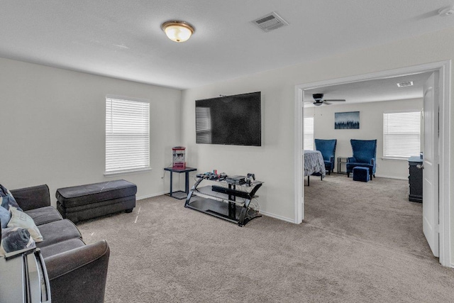 18909 James Carter Jr St, Manor, TX 78653 - carpeted living area with a ceiling fan and baseboards