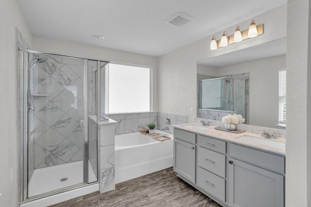 18909 James Carter Jr St, Manor, TX 78653 - bathroom featuring plenty of natural light, a bath, a stall shower, and double vanity
