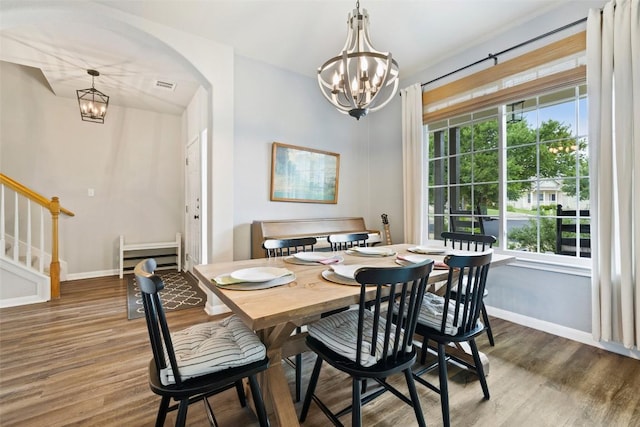 809 Bedford Ct, Georgetown, TX 78628 - dining area with a chandelier, wood finished floors, and baseboards
