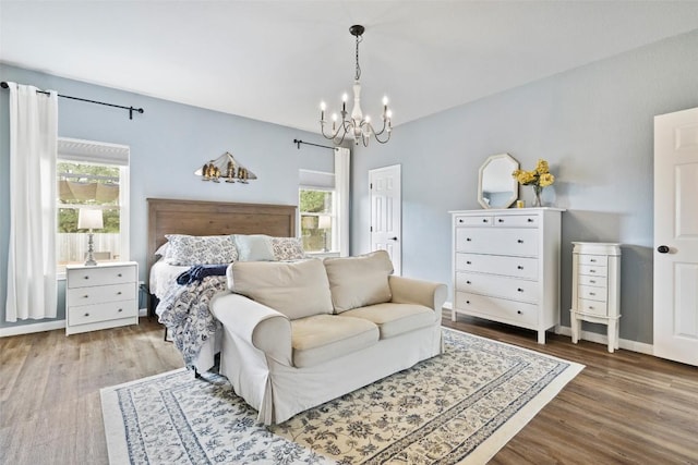 809 Bedford Ct, Georgetown, TX 78628 - bedroom with a chandelier, multiple windows, and wood finished floors