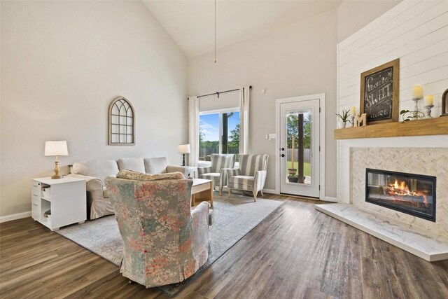 809 Bedford Ct, Georgetown, TX 78628 - living area featuring high vaulted ceiling, wood finished floors, a high end fireplace, and baseboards