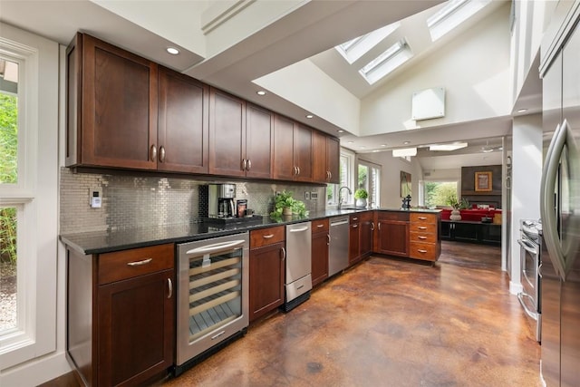 4305 Cliffwood Cir, Austin, TX 78759 - kitchen with wine cooler, concrete floors, stainless steel appliances, a peninsula, and decorative backsplash