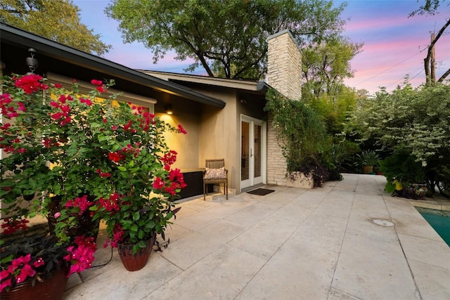 4305 Cliffwood Cir, Austin, TX 78759 - patio terrace at dusk featuring a patio area and french doors