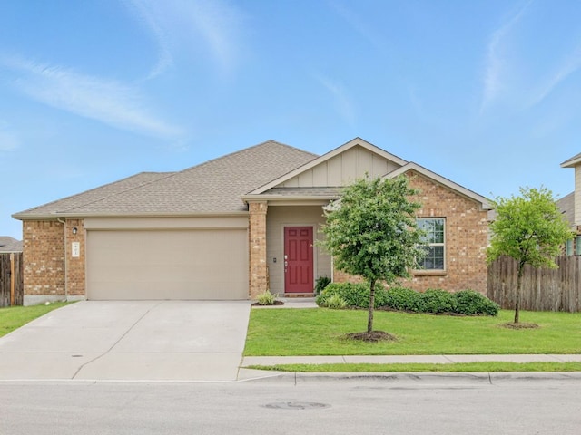601 Sassafras St, Hutto, TX 78634 - view of front of home featuring a garage, brick siding, concrete driveway, and board and batten siding