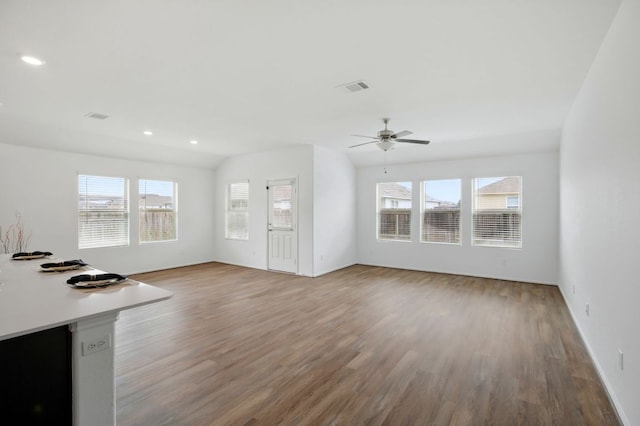601 Sassafras St, Hutto, TX 78634 - unfurnished living room featuring wood finished floors, a ceiling fan, recessed lighting, baseboards, and vaulted ceiling