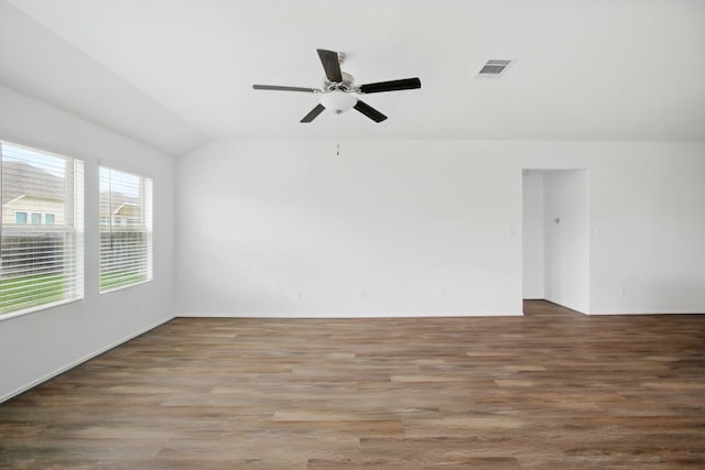 601 Sassafras St, Hutto, TX 78634 - empty room with vaulted ceiling, a ceiling fan, and wood finished floors