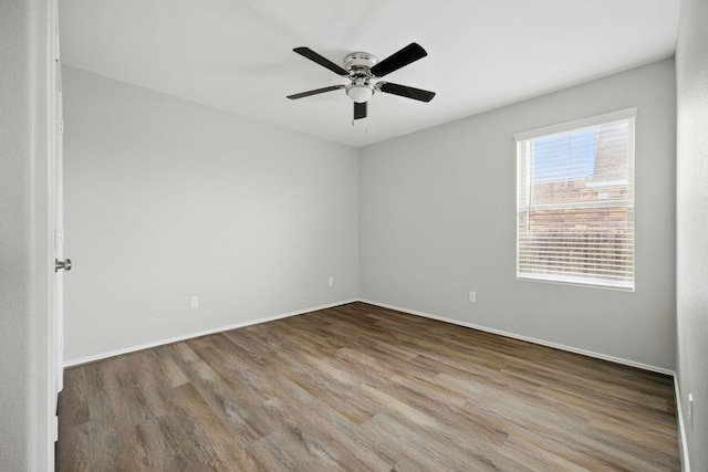 601 Sassafras St, Hutto, TX 78634 - spare room with wood finished floors, a ceiling fan, and baseboards