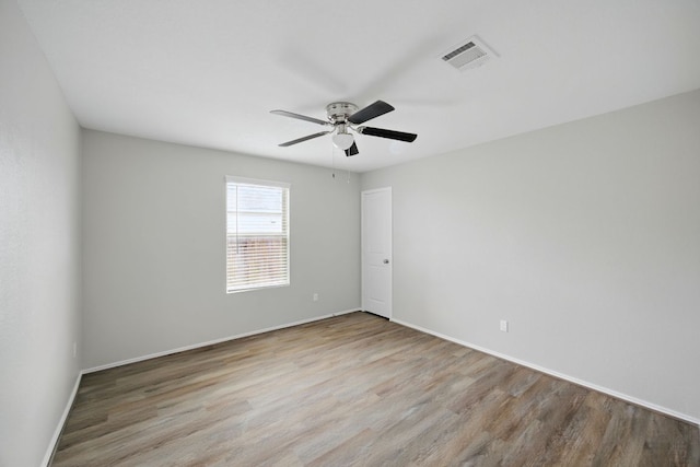 601 Sassafras St, Hutto, TX 78634 - empty room featuring wood finished floors, a ceiling fan, and baseboards