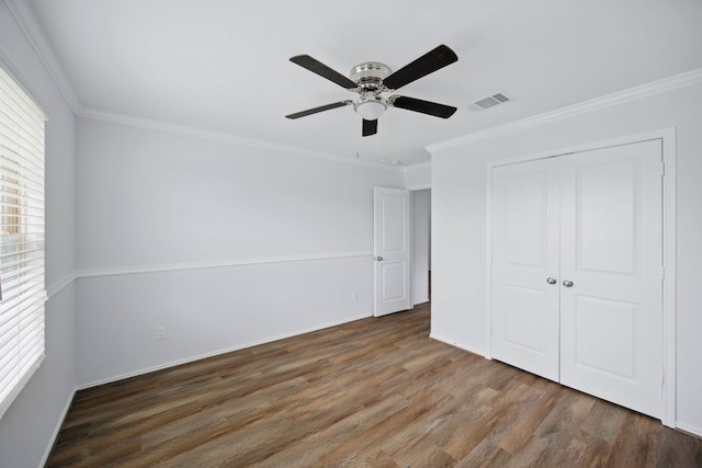 601 Sassafras St, Hutto, TX 78634 - unfurnished bedroom with wood finished floors, ornamental molding, a closet, ceiling fan, and baseboards