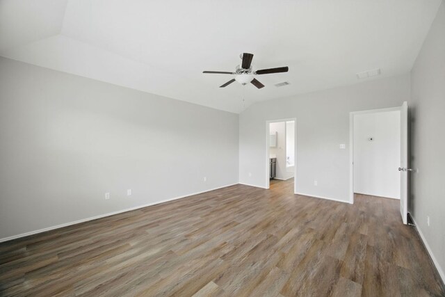 601 Sassafras St, Hutto, TX 78634 - unfurnished bedroom featuring wood finished floors, baseboards, a ceiling fan, and ensuite bathroom