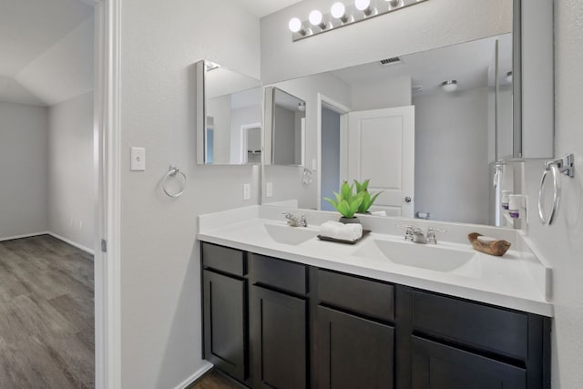 601 Sassafras St, Hutto, TX 78634 - bathroom with double vanity, wood finished floors, and baseboards