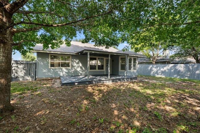 223 Keystone Loop, Kyle, TX 78640 - view of front of home with a fenced backyard, a shingled roof, stucco siding, and a patio