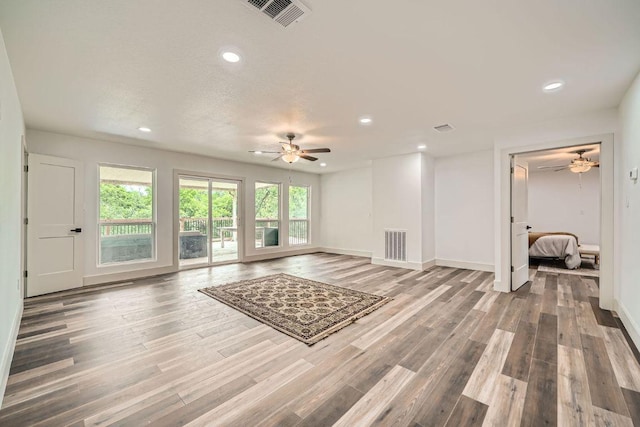 3610 Quiette Dr, Austin, TX 78754 - unfurnished living room featuring ceiling fan, recessed lighting, wood finished floors, and baseboards