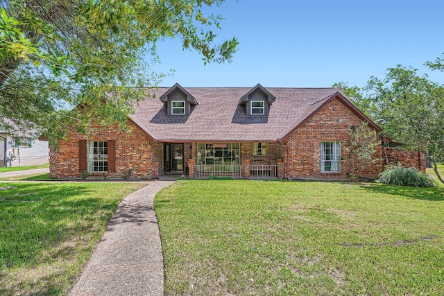 3610 Quiette Dr, Austin, TX 78754 - view of front of property with covered porch, brick siding, and a front yard