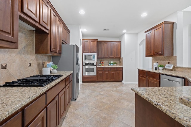 16413 Broadbay Dr, Austin, TX 78717 - kitchen with appliances with stainless steel finishes, decorative backsplash, light stone counters, recessed lighting, and baseboards