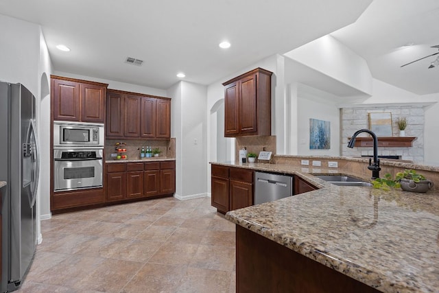 16413 Broadbay Dr, Austin, TX 78717 - kitchen with appliances with stainless steel finishes, a sink, tasteful backsplash, light stone counters, and recessed lighting