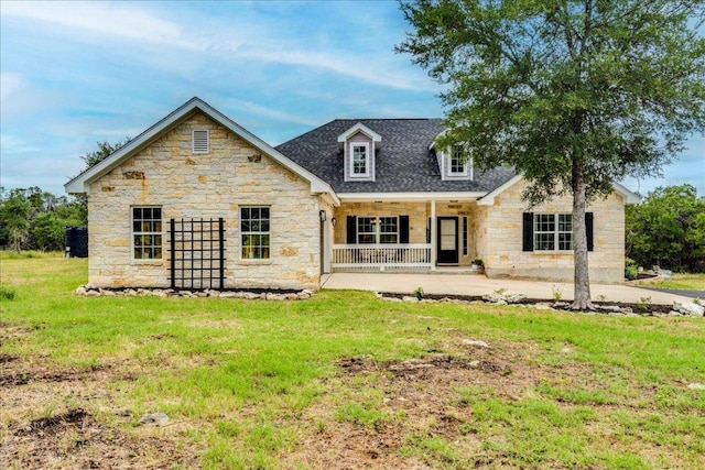 1033 Castleway Rd, New Braunfels, TX 78132 - rear view of house featuring stone siding, a lawn, a shingled roof, and covered porch