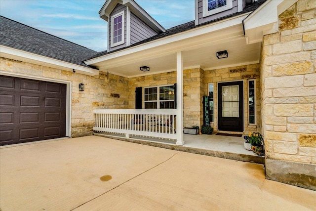 1033 Castleway Rd, New Braunfels, TX 78132 - view of exterior entry featuring stone siding, a porch, concrete driveway, and a shingled roof
