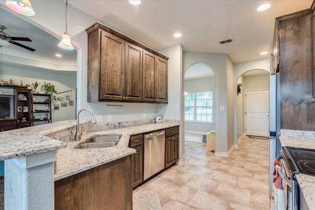 1033 Castleway Rd, New Braunfels, TX 78132 - kitchen with stainless steel appliances, arched walkways, ceiling fan, light stone countertops, and recessed lighting