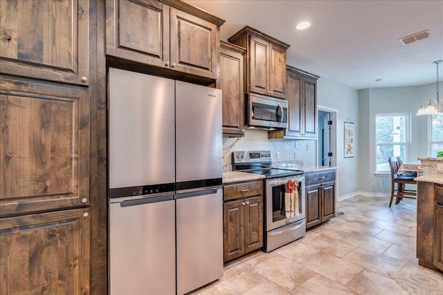 1033 Castleway Rd, New Braunfels, TX 78132 - kitchen featuring appliances with stainless steel finishes, decorative backsplash, recessed lighting, decorative light fixtures, and a chandelier