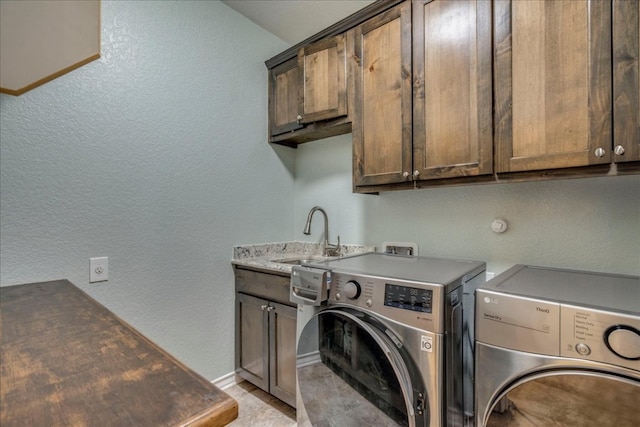 1033 Castleway Rd, New Braunfels, TX 78132 - laundry room featuring cabinet space, washing machine and dryer, and a textured wall