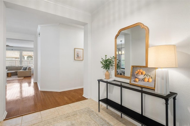 11817 Lake Stone Dr, Austin, TX 78738 - hallway featuring arched walkways, wood finished floors, crown molding, and baseboards