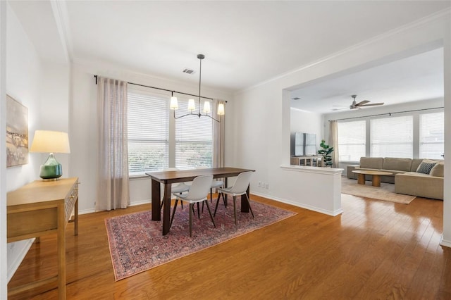 11817 Lake Stone Dr, Austin, TX 78738 - dining area with a chandelier, plenty of natural light, wood finished floors, ornamental molding, and baseboards