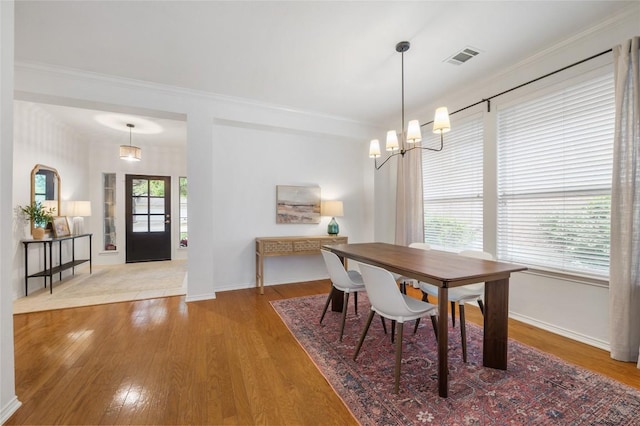 11817 Lake Stone Dr, Austin, TX 78738 - dining space with baseboards, a chandelier, wood finished floors, and crown molding