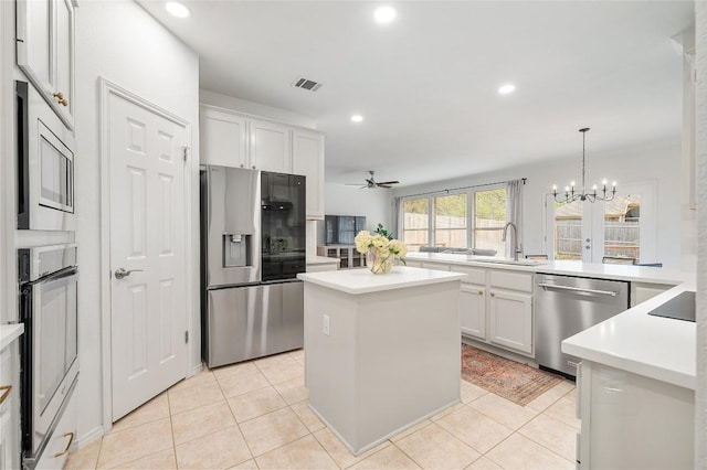 11817 Lake Stone Dr, Austin, TX 78738 - kitchen featuring stainless steel appliances, a sink, a kitchen island, recessed lighting, and light countertops