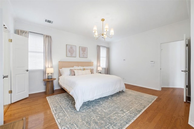 11817 Lake Stone Dr, Austin, TX 78738 - bedroom featuring a chandelier, light wood-style floors, multiple windows, and crown molding
