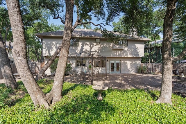 7915 Petaca Trl, Austin, TX 78729 - rear view of house featuring french doors and a patio area