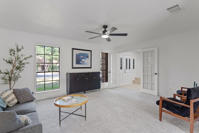 7915 Petaca Trl, Austin, TX 78729 - carpeted living room with french doors, a ceiling fan, and baseboards