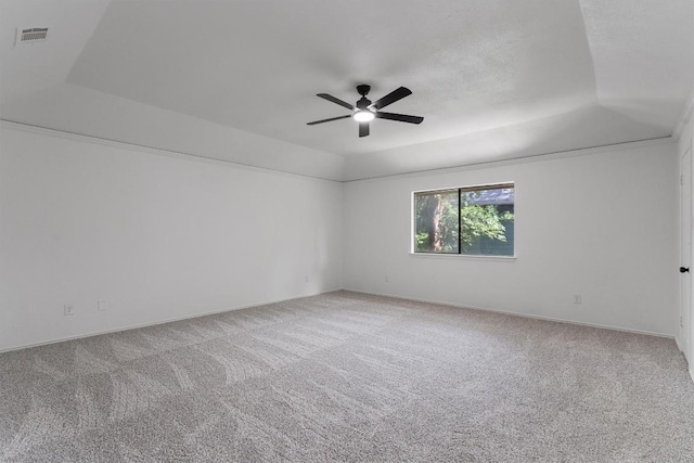 7915 Petaca Trl, Austin, TX 78729 - spare room featuring a tray ceiling, ceiling fan, carpet, and baseboards