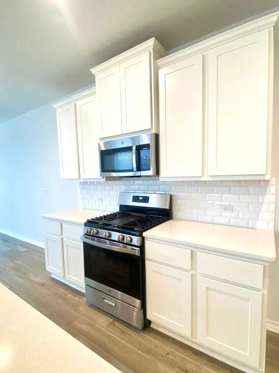 11713 Caithness Way, Austin, TX 78754 - kitchen with stainless steel appliances, light wood-type flooring, tasteful backsplash, and light countertops