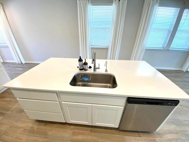 11713 Caithness Way, Austin, TX 78754 - kitchen with a sink, stainless steel dishwasher, baseboards, and white cabinetry