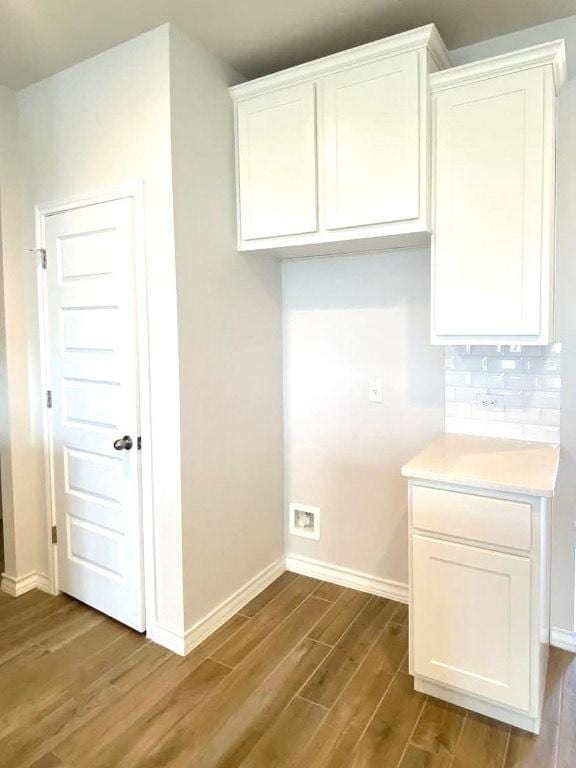 11713 Caithness Way, Austin, TX 78754 - kitchen featuring dark wood-type flooring, white cabinets, baseboards, tasteful backsplash, and light countertops