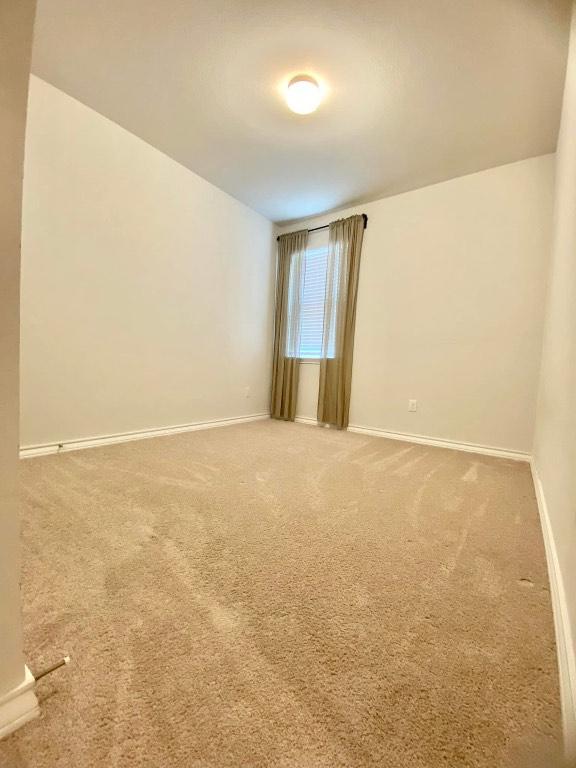 11713 Caithness Way, Austin, TX 78754 - empty room featuring baseboards and carpet floors