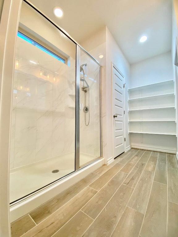11713 Caithness Way, Austin, TX 78754 - full bathroom with a shower stall, wood finished floors, and recessed lighting