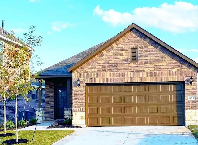 11713 Caithness Way, Austin, TX 78754 - view of front of property with brick siding, concrete driveway, and an attached garage