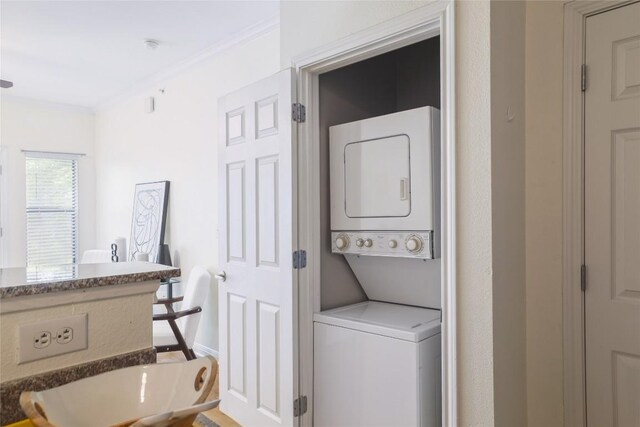 2502 Leon St Unit 208, Austin, TX 78705 - washroom with stacked washing machine and dryer and crown molding