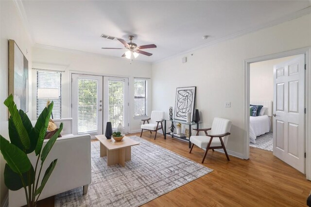 2502 Leon St Unit 208, Austin, TX 78705 - living area with a ceiling fan, crown molding, french doors, wood finished floors, and baseboards
