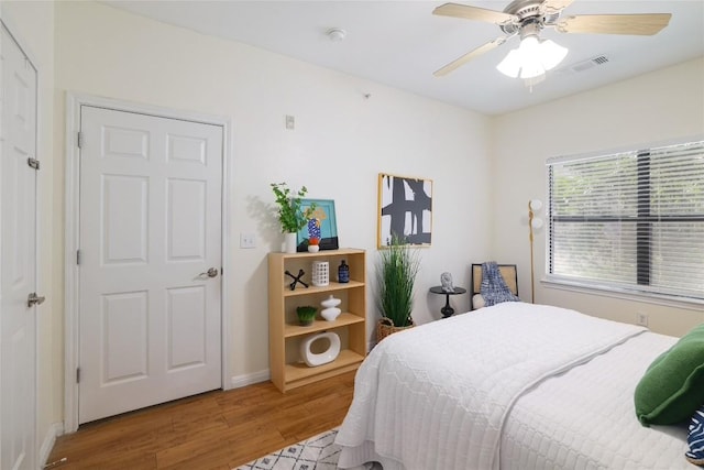 2502 Leon St Unit 208, Austin, TX 78705 - bedroom featuring wood finished floors, a ceiling fan, and baseboards