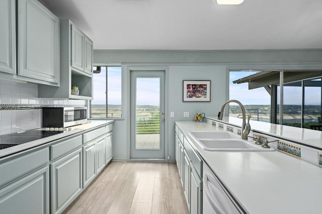 717 Mariner, Lakeway, TX 78734 - kitchen with a sink, light wood finished floors, dishwashing machine, and plenty of natural light
