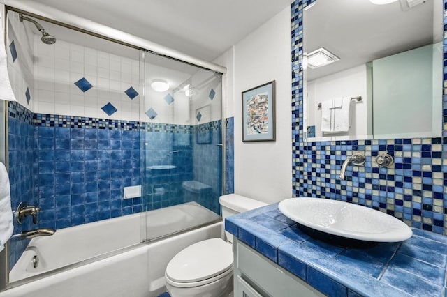 717 Mariner, Lakeway, TX 78734 - full bath featuring toilet, vanity, backsplash, and enclosed tub / shower combo