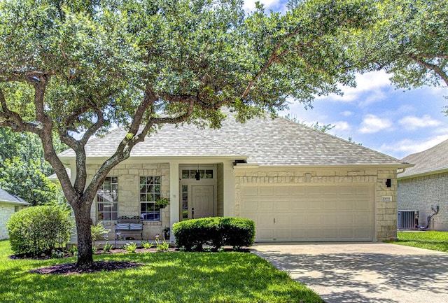 15053 Haley Holw, Austin, TX 78728 - view of front of home featuring stone siding, a shingled roof, a garage, central AC unit, and driveway